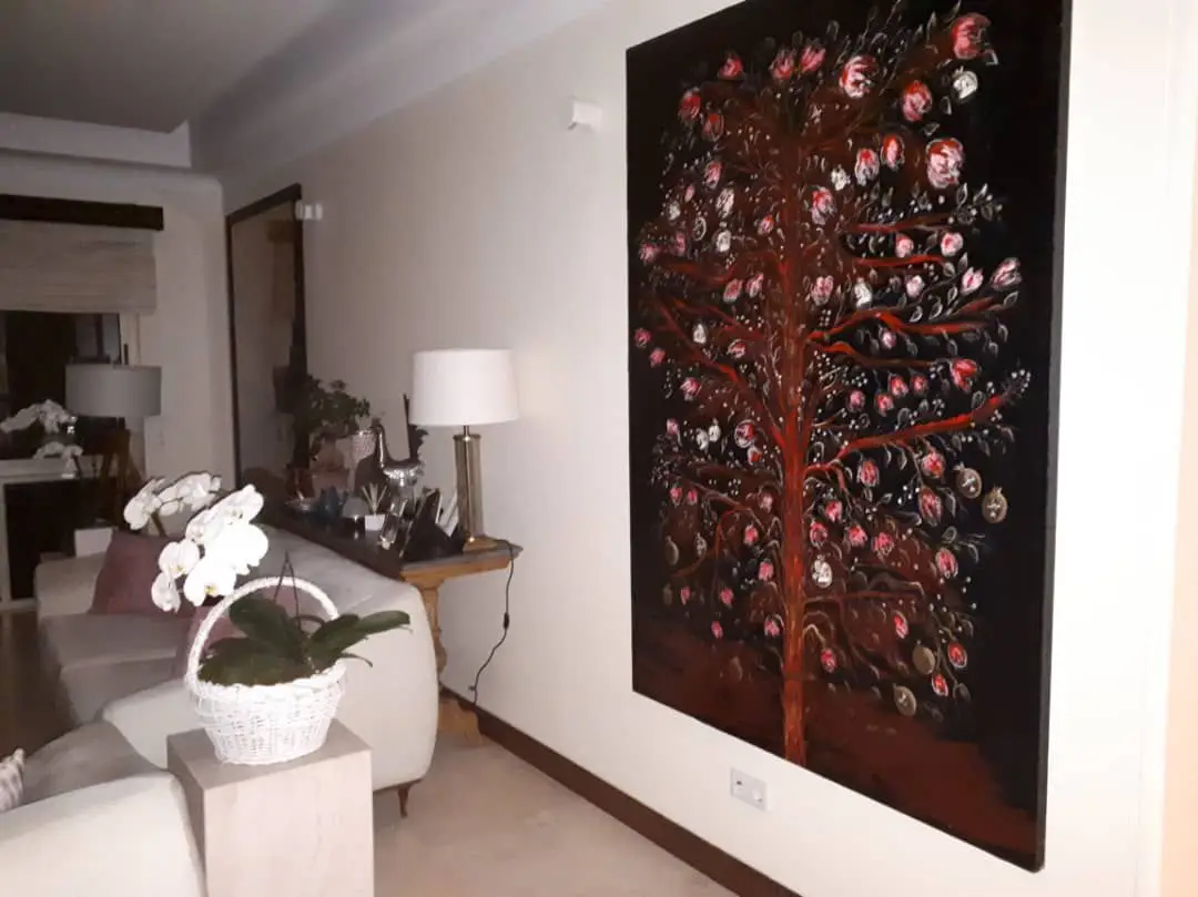 Living room with floral artwork on wall.