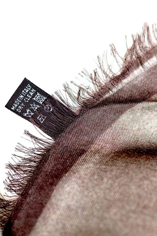 Close-up of a frayed fabric edge with label.