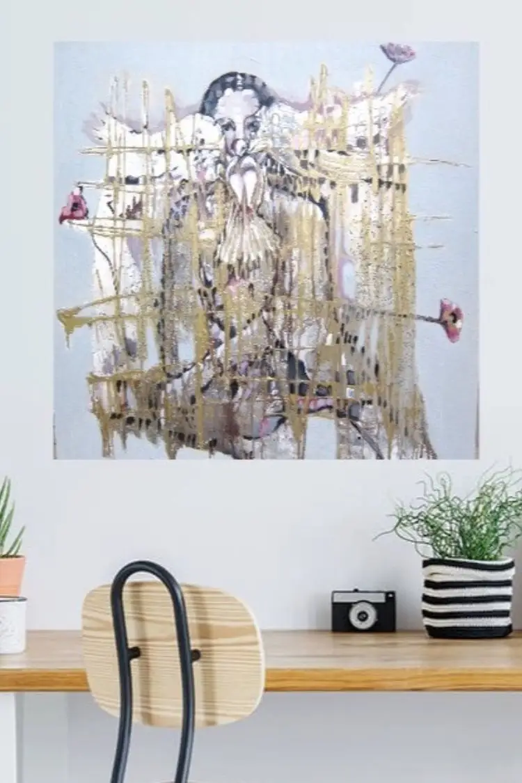 Abstract art painting above modern desk setting.