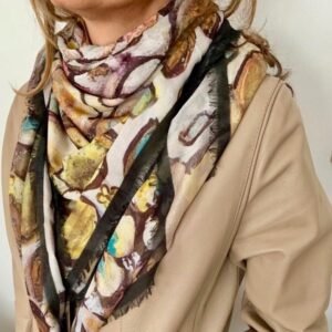 Colorful abstract scarf on beige coat.